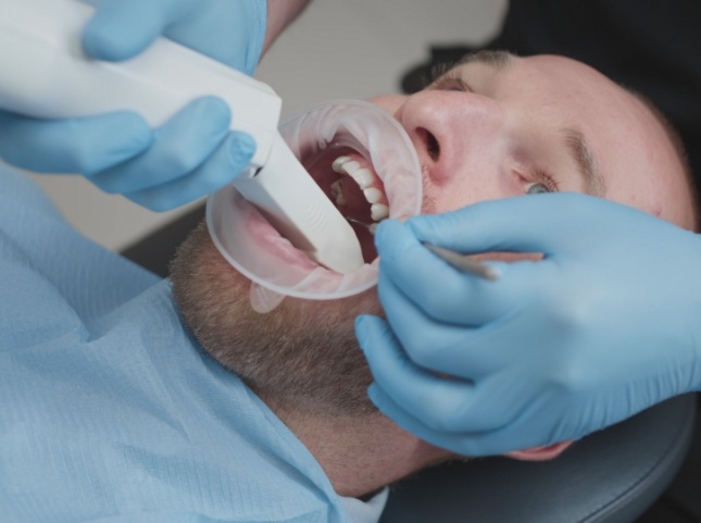Dentist scanning a patient for cavities