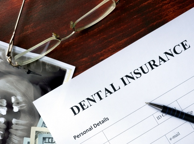 Paperwork on desk for dental insurance in San Ramon