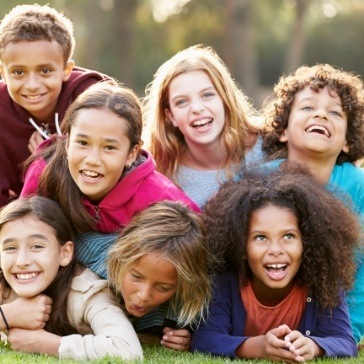 Group of kids laughing together outdoors