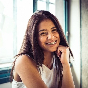 Teenage girl grinning and wearing braces