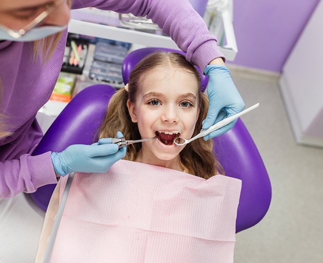 young child smiling while visiting dentist 